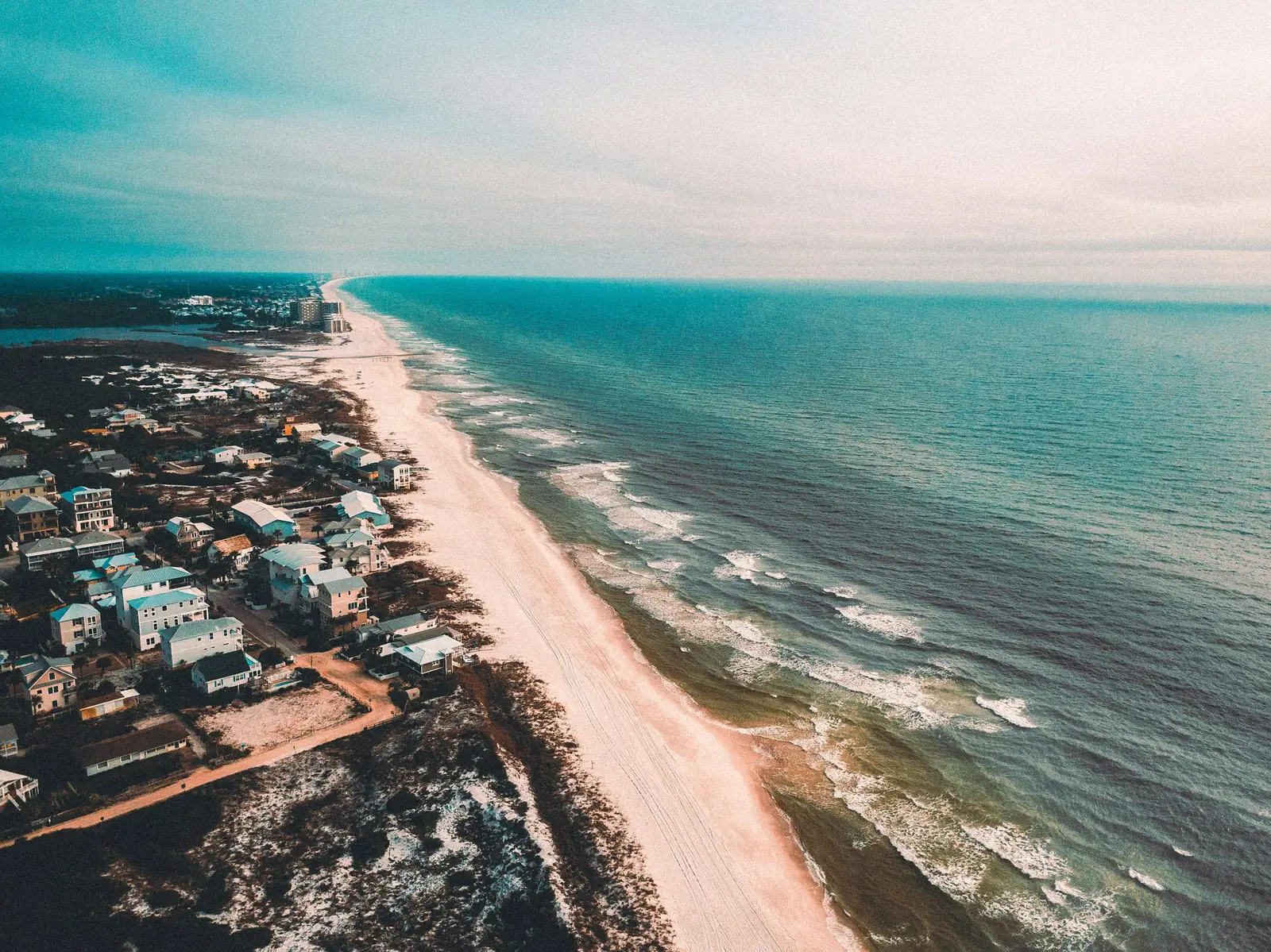 Aerial view of beach houses and the Gulf shoreline along 30A