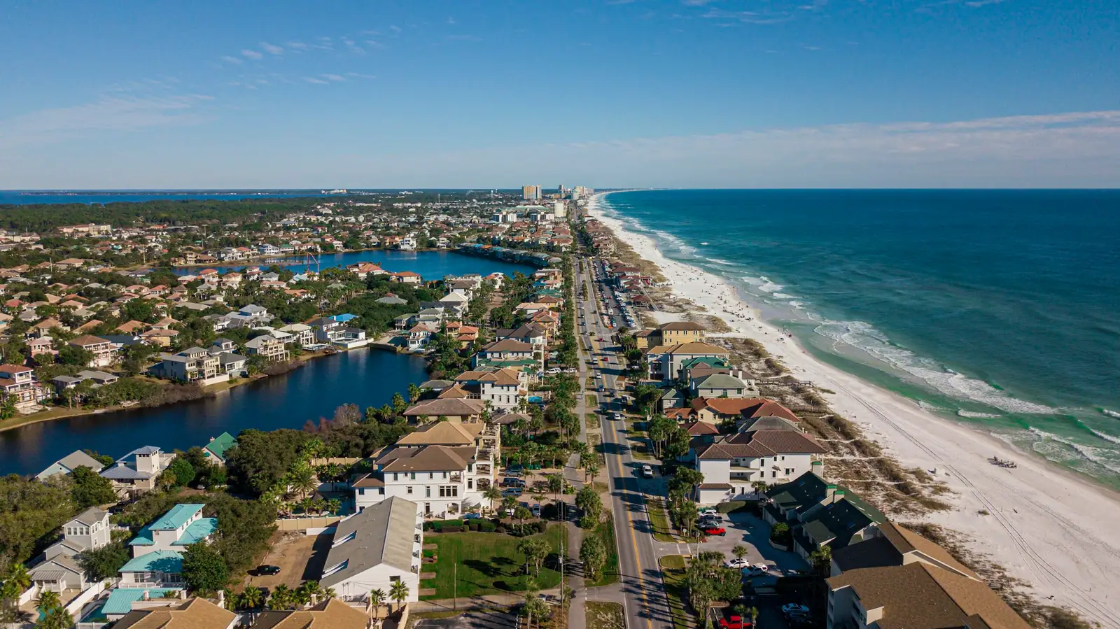 Aerial view of Destin homes, a bayou and the Gulf beach