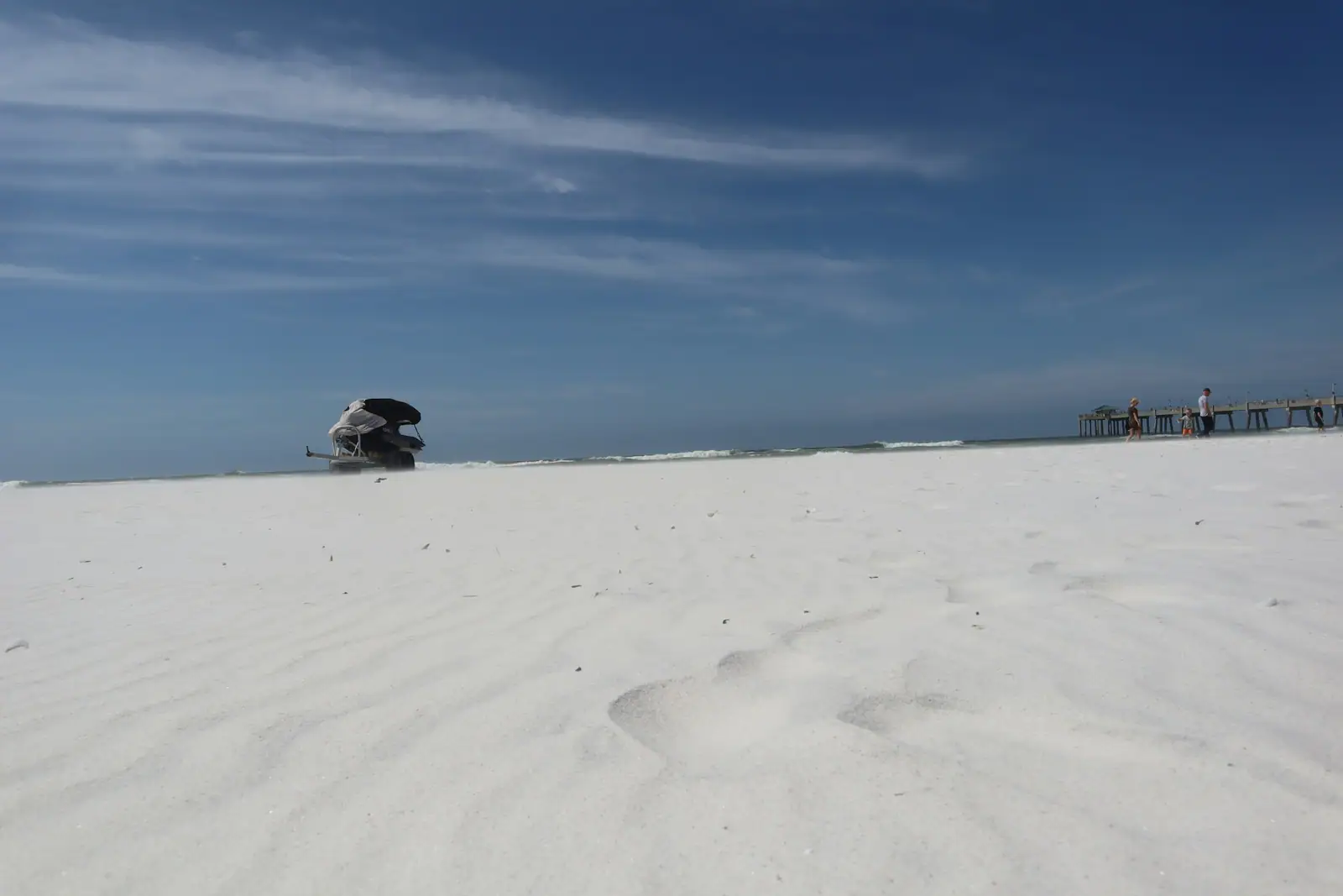 Wide white sand beach on Okaloosa Island under a blue sky